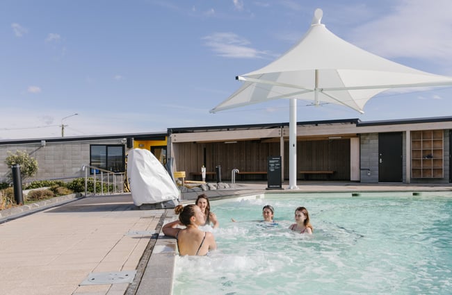 Friends chatting in the hot pools at He Puna Taimoana.