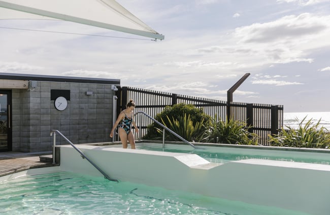 Woman walking into hot pool at He Puna Taimoana.