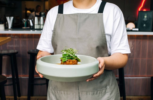 Staff holding plate of food from Hello Beasty, Auckland Viaduct Harbour.