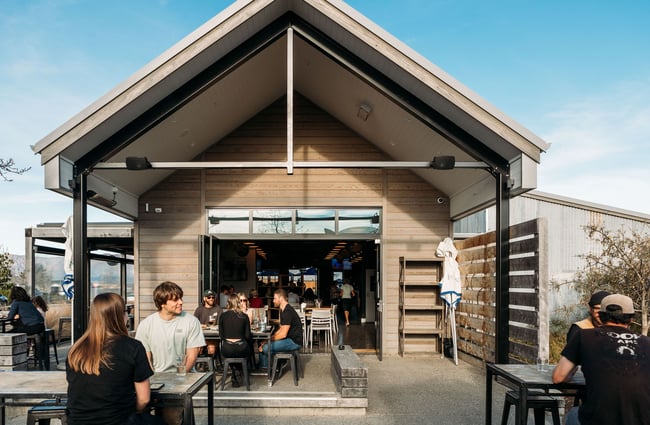 People sitting around the exterior dining area at hello RANGER.