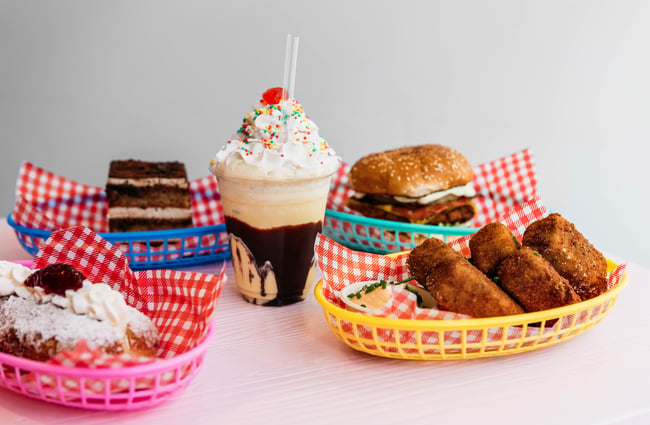 Burgers and thick shakes against a white background.