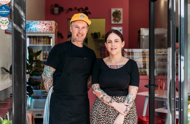 A man and woman posing for camera outside their cafe Hello Rosie.