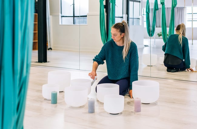 Woman playing crystal bowls at High Above.