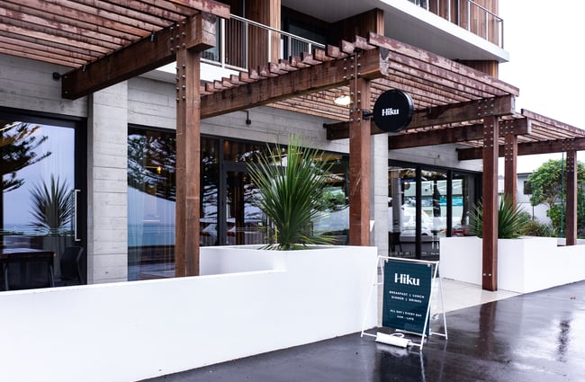 The wooden and white entrance to Hiku.