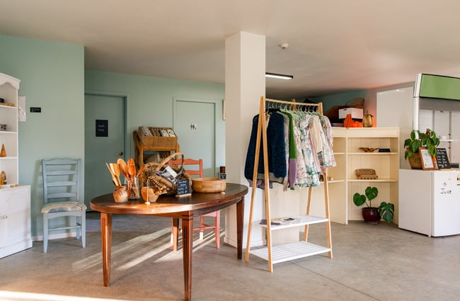 Shop interior with a rack of clothing at Hill Road Orchard & Farm Shop.