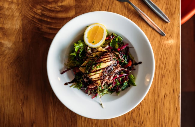 A plate of food on a wooden table.