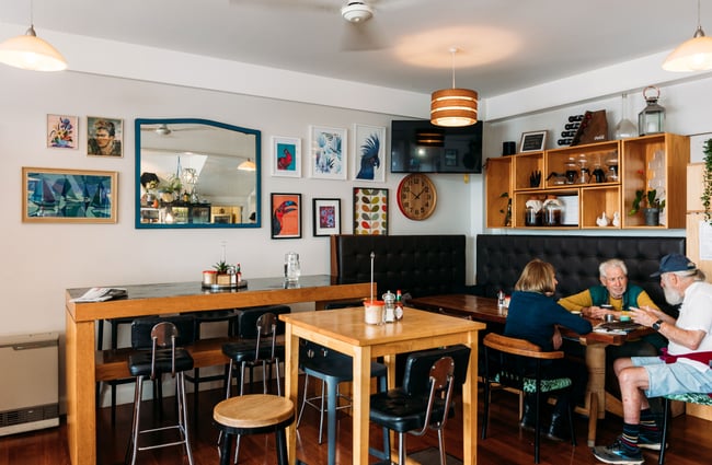 Customers dining at tables inside Hive Cafe in Eastbourne.