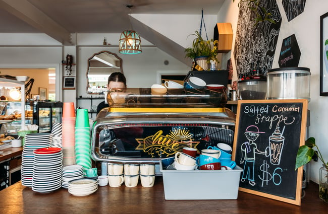 A staff member working behind a coffee machine.