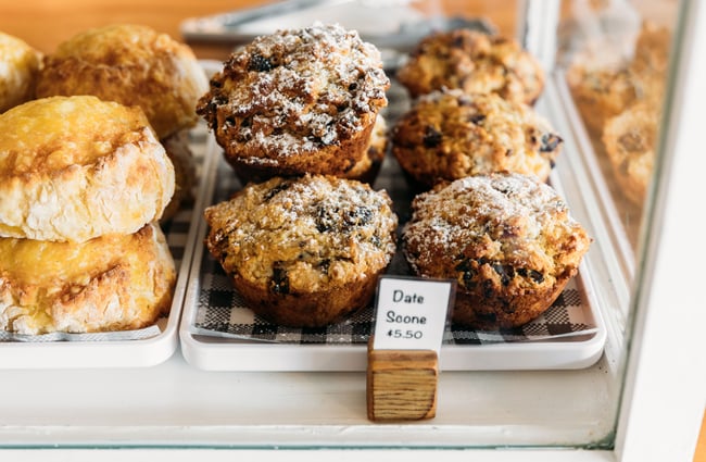 A close up of date scones in a glass cabinet.