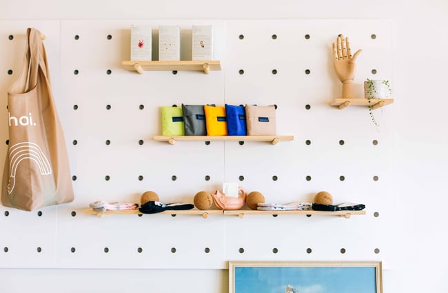 Shelves on white peg board.