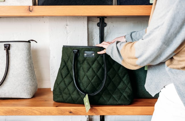 Hands opening a green bag at Honest Wolf in Rangitikei.