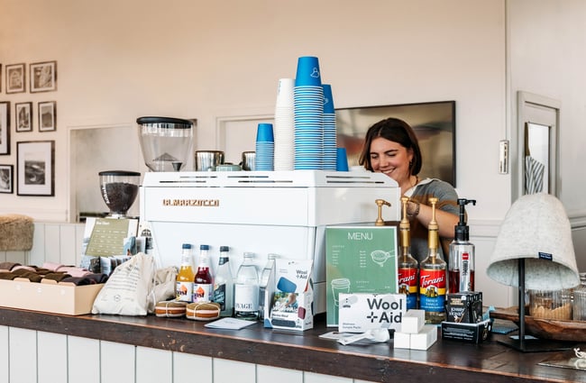 A woman behind a coffee machine at Honest Wolf in Rangitikei.