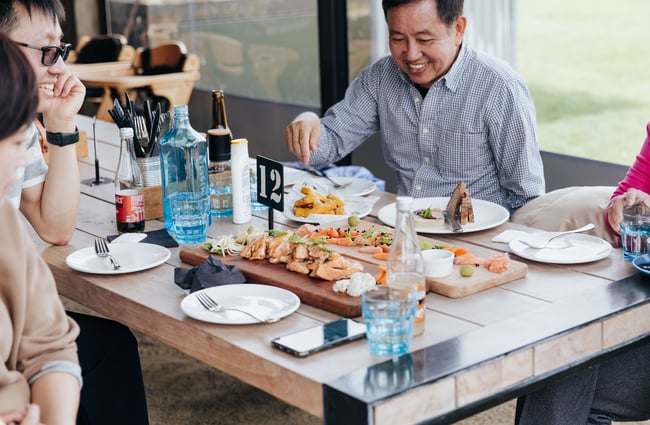 A table of people eating fresh fish.