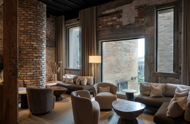 A hotel lobby waiting area decorated with rounded chairs and couches.