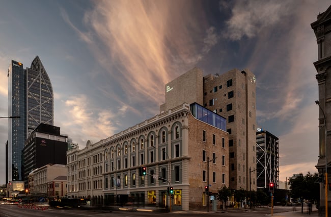 The large brick exterior of Hotel Britomart at dusk.