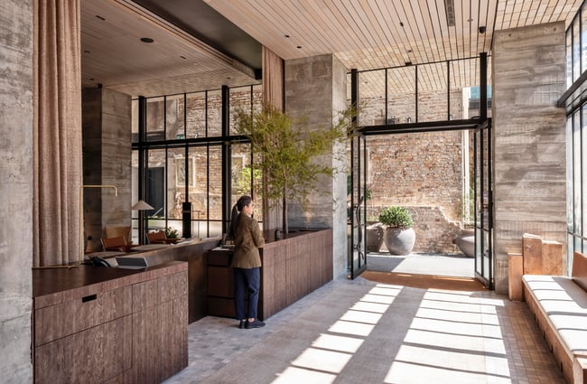 A staff member standing next to the counter at Hotel Britomart.