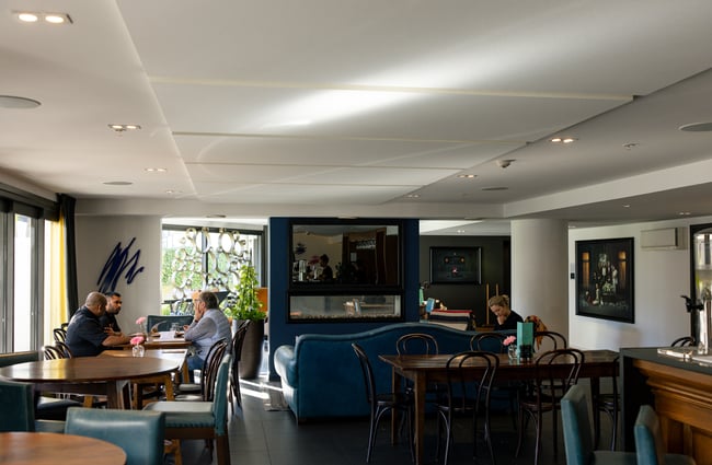 The dining room with fireplace at Hotel Montreal Christchurch.