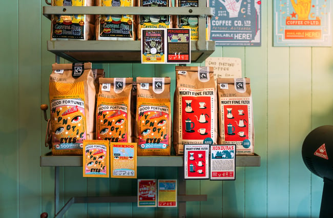Bags of Good Fortune coffee on shelf at cafe