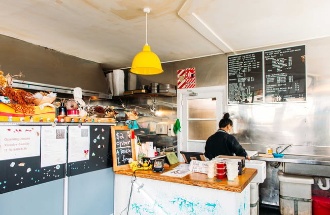 A woman working behind the counter at Huckle and Co.