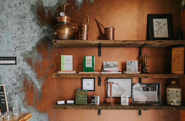 Gin books and paraphernalia on shelves on a wall inside Humdinger Gin Distillery in Geraldine.