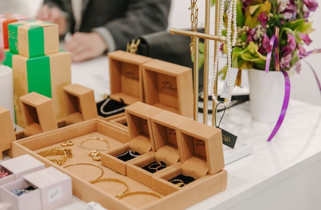 A close up of rings in boxes on a counter.