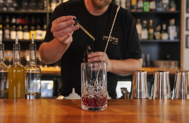 Bartender serving a up a drink at Imōto Lounge Bar.