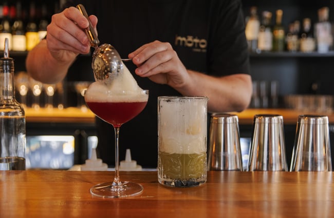 Bartending serving up a cocktail at Imōto Lounge Bar.