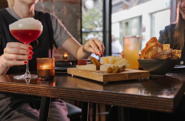 Customers enjoying a platter and drinks at Imōto Lounge Bar.