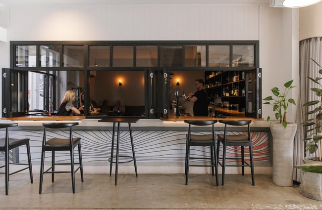 Bar seating and view through the window at Imōto Lounge Bar.