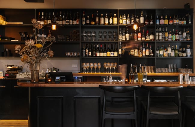 View of the bar and rows of spirits at Imōto Lounge Bar.