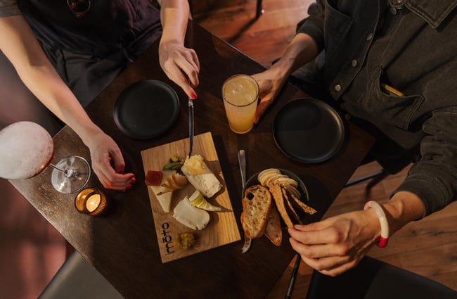 Customers enjoying a cheeseboard at Imōto Lounge Bar.