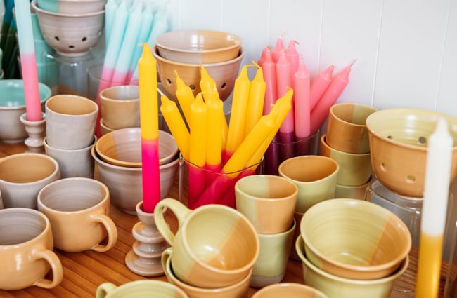 Close up of bright candles and ceramic mugs at Inc. Design in Ōamaru