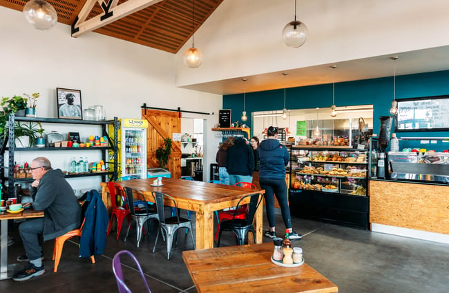People ordering at the cafe counter inside Industry Lane Cafe Alexandra Central Otago.