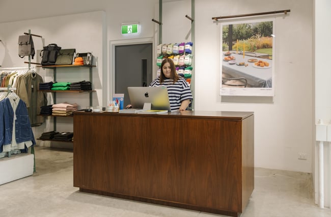 Shop assistant at the till at Infinite Definite.