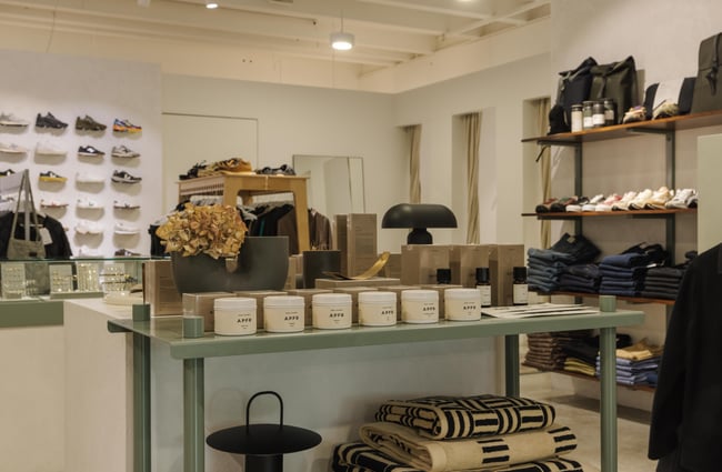 Shoe display in the background and other accessories in the foreground at Infinite Definite.