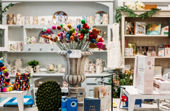 Homewares and candles on display on a table inside Intrigue Boutique in Bulls.