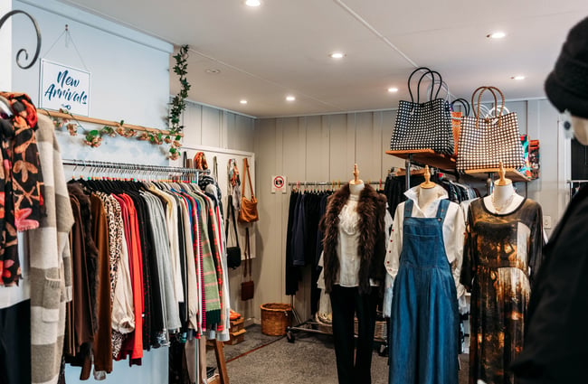 Clothing on racks and mannequins inside Intrigue Boutique in Bulls.
