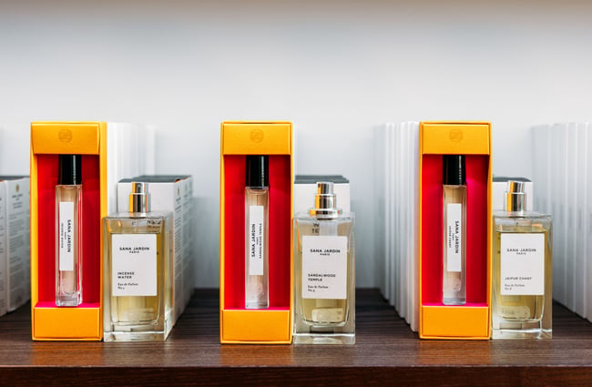 A close up of bottles of perfume lined up in a row.