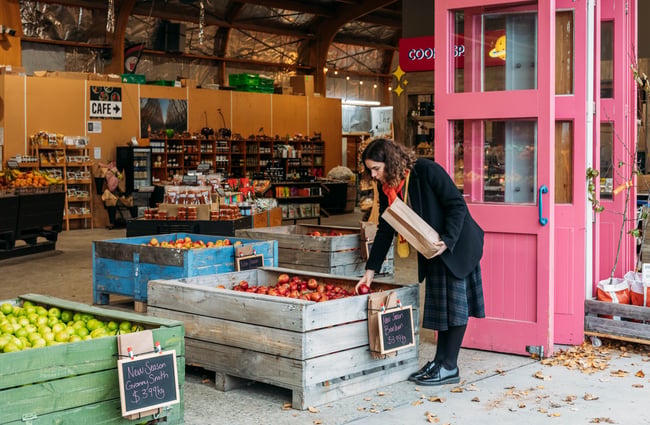Customer selecting fruit at the shop at Jackson Orchards.