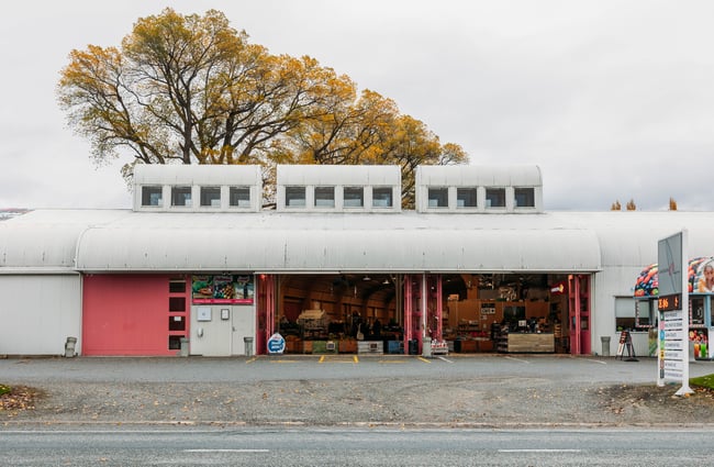 Pink and grey building exterior of the shop at Jackson Orchards.