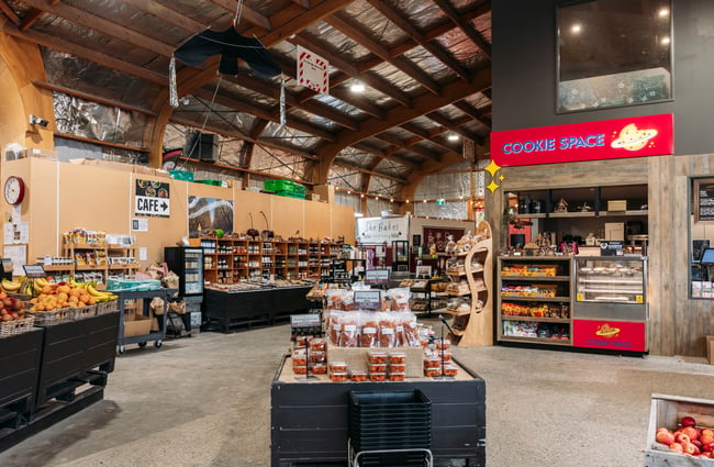 Shelves of products and Cookie Space stand in the shop area of Jackson Orchards.
