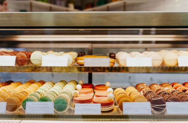 Rows of macarons in a glass cabinet at J’aime les macarons in Christchurch.