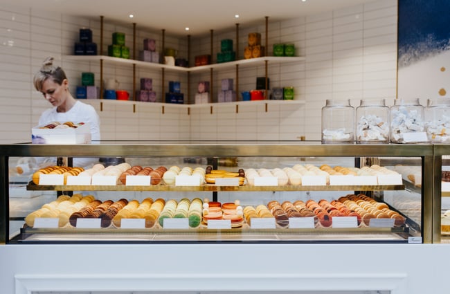 Glass cabinet of macarons at J’aime les macarons in Christchurch.