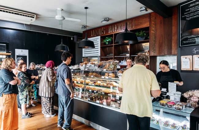 Customers waiting to order at the counter at Janus Bakkerij.