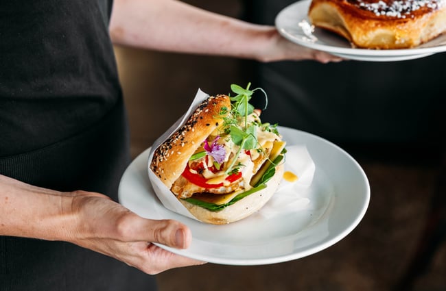 Sandwich and pastry on plates at Janus Bakkerij.