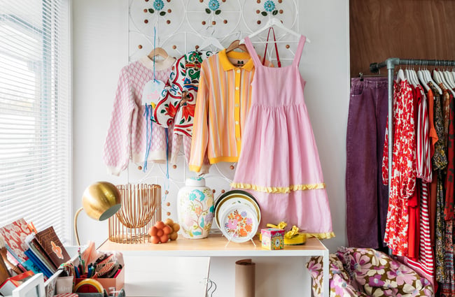 Pink and yellow clothes on a wall.