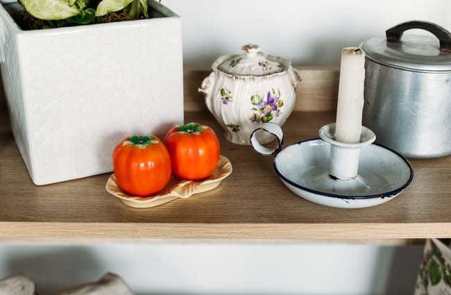 A close up of vintage kitchenware on a shelf.