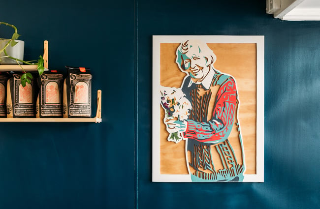 A wooden cutout portrait of an old lady.