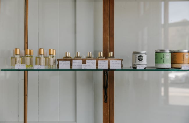A close up of mini bottles of perfume on a shelf.