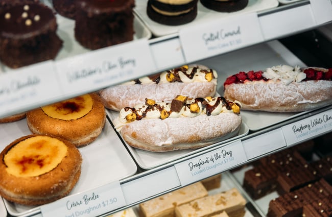 A close up of pastries in a cabinet.